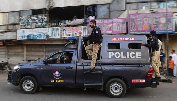 Police patrol in a market area in Karachi on May 24, 2021. — AFP