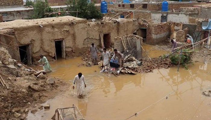 Residents clear debris of a damaged house due to a heavy monsoon rainfall on the outskirts of Quetta, Balochistan on July 5, 2022.— AFP