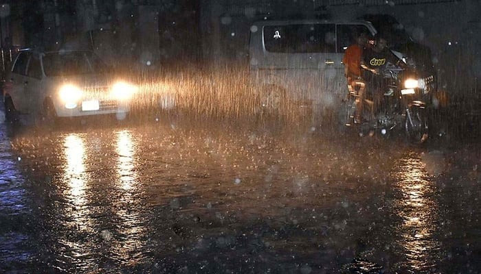 People commuting during heavy rain on June 25, 2023. — APP