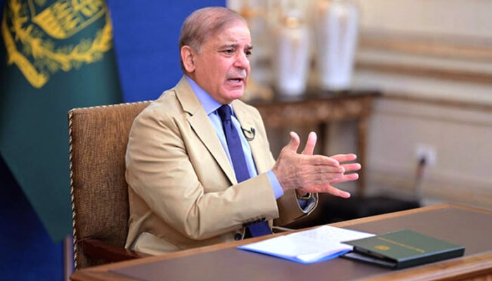 This photo shows PM Shehbaz Sharif addressing the nation via televised speech in this undated photo. — APP