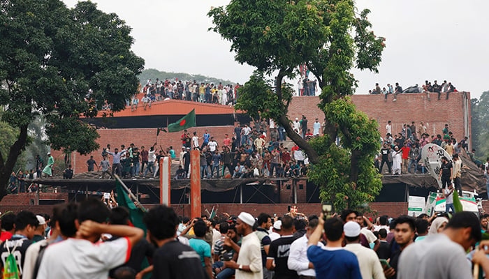 People enter the Ganabhaban, the Prime Ministers residence, after the resignation of the Sheikh Hasina in Dhaka, Bangladesh, August 5, 2024. — Reuters