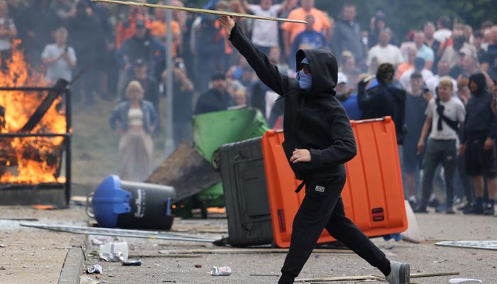 Flames burn as demonstrators take part in an anti-immigration protest, in Rotherham, Britain, August 4, 2024. — Reuters