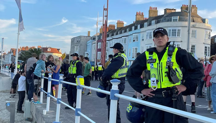 Police wearing riot protection equipment patrol the seafront esplanade following an anti-immigration protest in Weymouth, Britain August 4, 2024. — Reuters