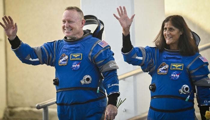 Nasa astronauts Barry Wilmore (L) and Sunita Williams waving to the Nasa crew moments before boarding the Boeings Starliner spacecraft for an eight-day mission at the Cape Canaveral, Florida, on June 5, 2024.— AFP