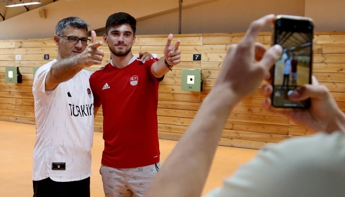 Turkish shooter Yusuf Dikec poses with a fan following a training in Ankara, Turkey, on August 8, 2024. —Reuters