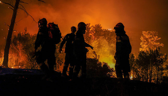 Firefighters at work to extinguish wildfire in Dionysos, Greece on August 12, 2024. — Reuters