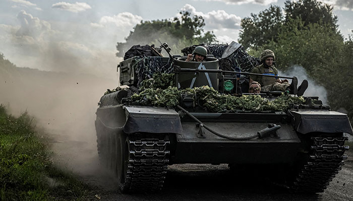 Ukrainian servicemen ride a military vehicle, amid Russias attack on Ukraine, near the Russian border in Sumy region, Ukraine on August 11, 2024. — Reuters