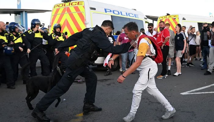 A policeman stopping a protestor. — AFP/file