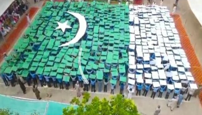 1,200 students form a huge flag in Pakpattan. — APP