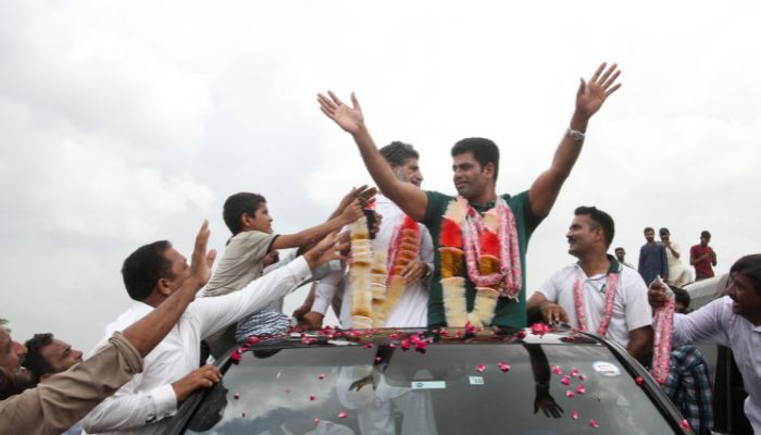 Arshad Nadeem, Pakistans first Olympic gold medallist athlete in the mens javelin, waves to people as they gather to welcome him at his hometown in Mian Channu, Punjab, Pakistan on August 11, 2024. — Reuters