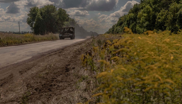 A Ukrainian armoured military vehicle drives on a road towards the border with Russia, in the Sumy region of Ukraine, on August 14, 2024. — AFP