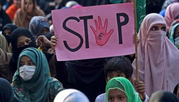 Woman holding a placard reading Stop rape during a protest against an alleged gang rape of a woman, in Lahore, on September 17, 2020. — AFP