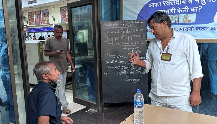 A man speaks to a guard at the entrance of a hospital in Mumbai, inquiring if it is operational after a nationwide strike was declared by the Indian Medical Association to protest the rape and murder of a trainee medic at a government-run hospital in Kolkata, India, August 17, 2024. — Reuters