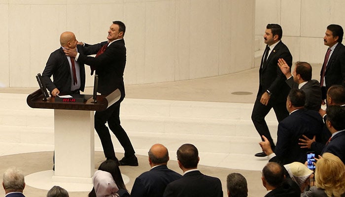 Turkeys AK Party lawmaker Alpay Ozalan scuffles with Workers Party of Turkey (TIP) lawmaker Ahmet Sik, who was speaking during an extraordinary meeting of the Turkish parliament to discuss jailed opposition lawmaker Can Atalays return to the assembly, in Ankara, Turkey August 16, 2024. — Reuters