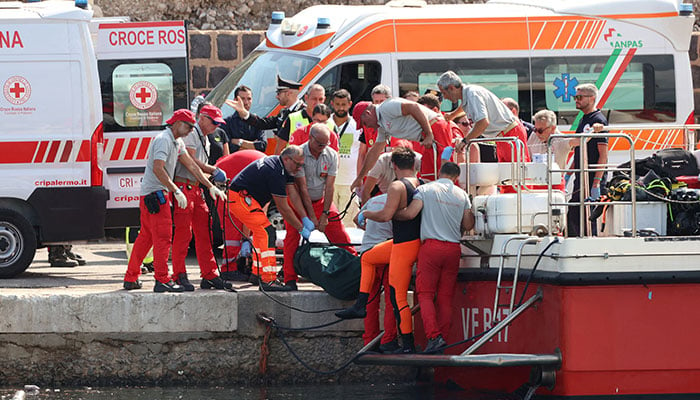 Emergency services carry a body bag after a sailboat sank in the early hours of Monday, off the coast of Porticello, near the Sicilian city of Palermo, Italy, August 19, 2024. — Reuters