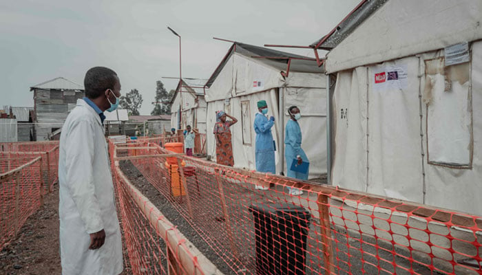 Health workers walk at the Mpox treatment centre at Nyiragongo General Referral Hospital, north of Goma on August 17, 2024. — AFP