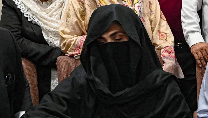 Bushra Bibi signs a surety bond for a bail in various cases at the Registrars Office at the Lahore High Court on July 17, 2023. — AFP