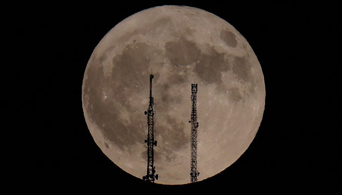 A supermoon rises behind television antennas in Ronda, Spain, August 19, 2024. — Reuters