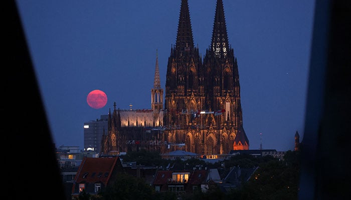 A supermoon rises behind the Cologne Cathedral in Cologne, Germany, August 19, 2024. — Reuters