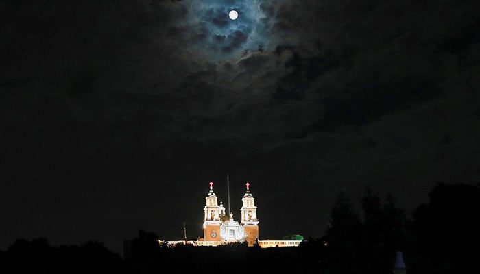 A supermoon rises next to the Santuario de la Virgen de los Remedios church in San Pedro Cholula, Puebla, Mexico, August 19, 2024. — Reuters