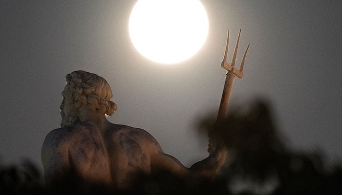 A supermoon is pictured behind a Poseidon statue from Kastellet in Copenhagen Copenhagen, Denmark, August 19, 2024. — Reuters