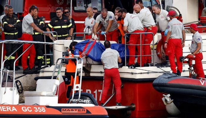 Rescue personnel transport a body bag after a luxury yacht, which was carrying British entrepreneur Mike Lynch, sank off the coast of Porticello, near the Sicilian city of Palermo, Italy on August 21, 2024. — Reuters