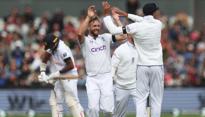 Englands Chris Woakes celebrates with teammates after taking the wicket of Sri Lankas Kamindu Mendis, caught out by Jamie Smith, at Old Trafford cricket stadium in Manchester, Britain, on August 21, 2024. —Reuters