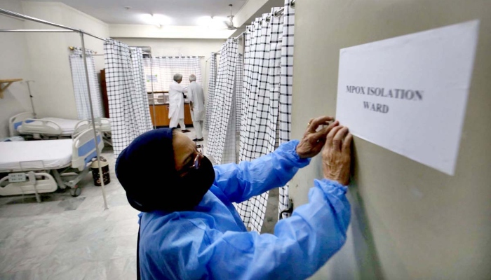 A paramedical staff prepares an isolation ward set up as a preventative measure at Police & Services Hospital, following confirmation of a case of mpox in Khyber Pakhtunkhwa, on August 20, 2024. APP