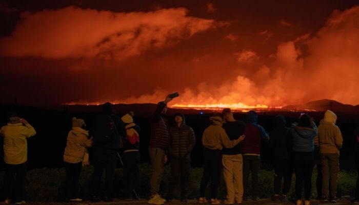 People taking pictures of the lava expulsion as a result of the volcanic eruption near Grindavik on the Icelandic peninsula of Reykjanes on August 23, 2024. — AFP