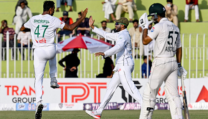 Bangladeshs Shoriful Islam (L) celebrates with teammate (C) after taking the wicket of Pakistans Saim Ayub (not pictured) during the fourth day of the first Test cricket match, Pakistan vs Bangladesh, Rawalpindi Cricket Stadium, August 24, 2024. — AFP