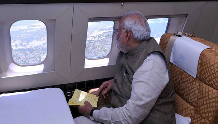 Indian Prime Minister Narendra Modi sitting in an aircraft. — AFP/File