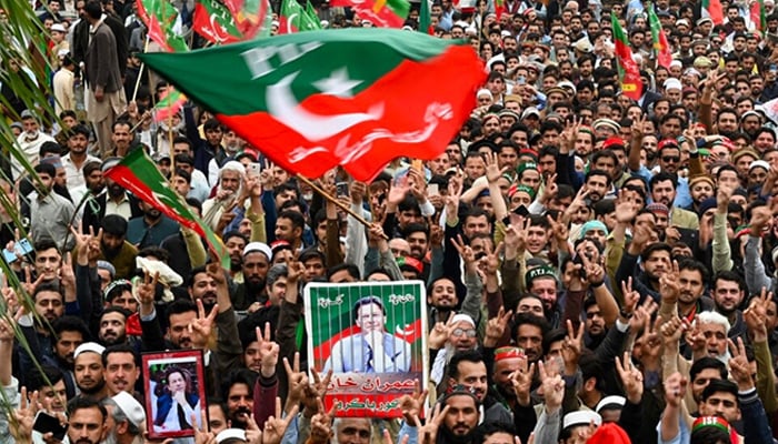 PTI supporters hold portraits of former prime minister Imran Khan as they protest against the alleged rigging in February 8 nationwide elections, Peshawar, March 10, 2024. — AFP/File