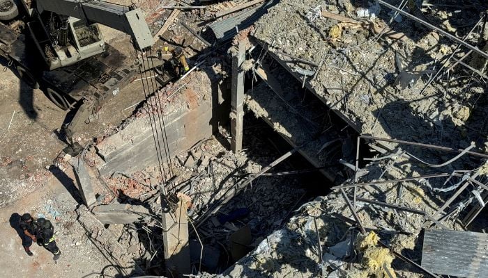 Emergency services personnel stand at the site where a hotel in Kramatorsk, Donetsk region, Ukraine, was hit by a Russian missile attack during the Russian attack on Ukraine on August 25, 2024.