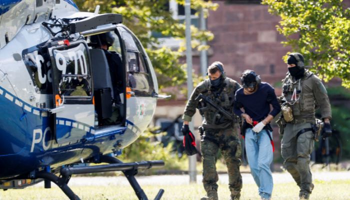 A 26-year-old Syrian man, who is the suspect in custody for a stabbing rampage in the western German city of Solingen in which several individuals were killed, is escorted by police as he leaves the Federal Public Prosecutor in Karlsruhe, Germany on August 25, 2024. — Reuters