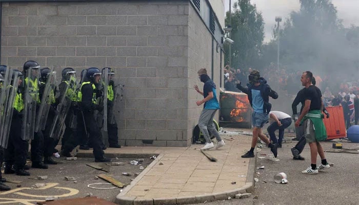 Demonstrators clash with police officers during an anti-immigration protest, in Rotherham, Britain on August 4, 2024. — Reuters