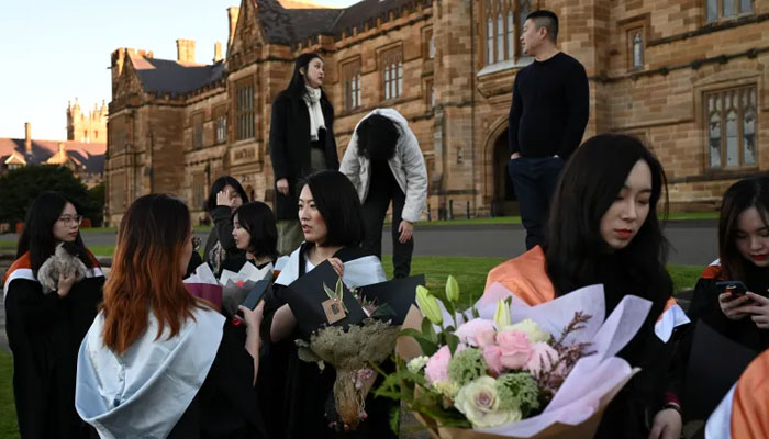 University students prepare to take photos following their graduation ceremony at University of Sydney in Sydney, Australia. — Reuters/File