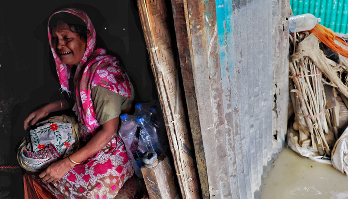 A flood-affected woman cries amid severe flooding in the Fazilpur area of Feni, Bangladesh, August 26, 2024. — Reuters