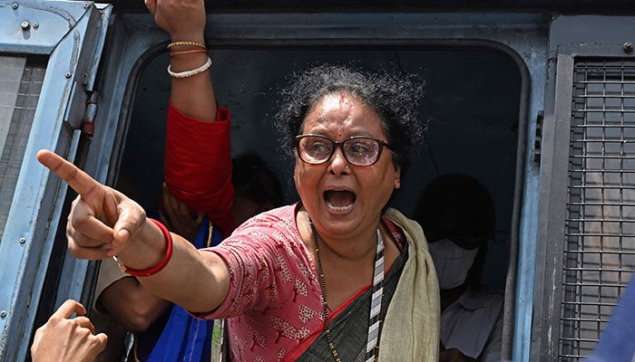 An activist of the Bharatiya Janata Party (BJP) shouts slogans after being detained by police during a protest rally, in Kolkata on August 28, 2024. — AFP