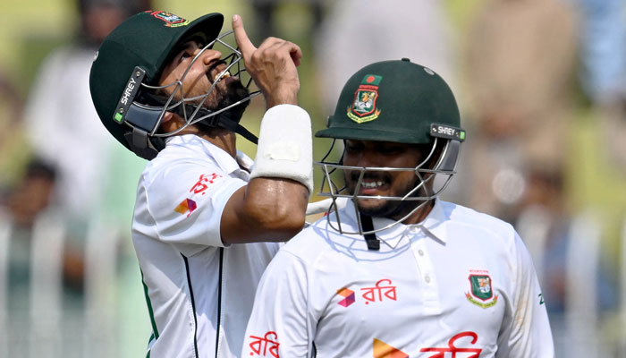 Bangladeshs Shadman Islam (L) and Zakir Hasan celebrate after their teams win during the fifth and final day of the first Test cricket match between Pakistan and Bangladesh at the Rawalpindi Cricket Stadium in Rawalpindi on August 25, 2024. — AFP