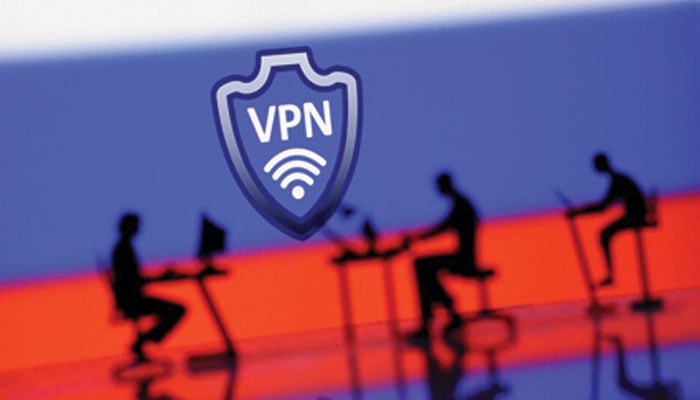 A VPN sign is seen in front of silhouetted miniatures of people with computers in this illustration taken, April 23, 2024. — Reuters