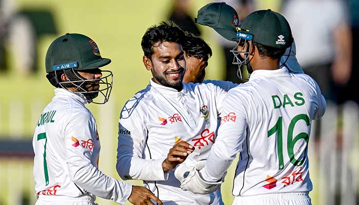 Mehidy Hasan Miraz (C) celebrates with teammates after taking five wickets during the second day of the last Test cricket match between Pakistan and Bangladesh in Rawalpindi on August 31, 2024. — AFP