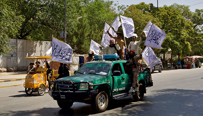 Members of the Taliban carrying flags ride motorbikes as they participate in a rally to mark the third anniversary of the fall of Kabul, in Kabul, Afghanistan, August 14, 2024. — Reuters