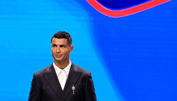 Cristiano Ronaldo stands on stage during the ceremony of the draw for the group stage of the 2024-2025 UEFA Champions League, at Grimaldi Forum in Monaco on August 29, 2024. — AFP