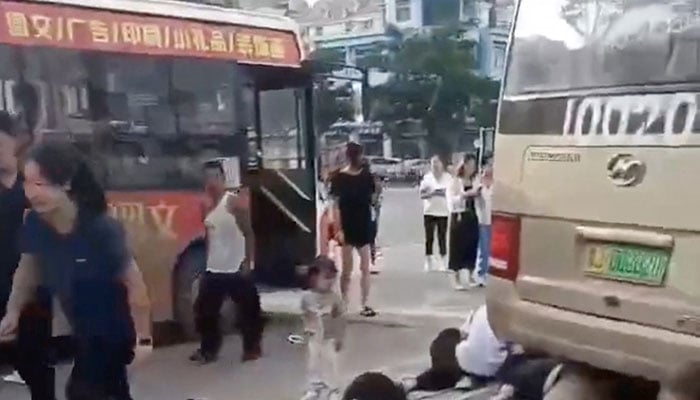 Commotion outside a school as a bus slammed into people gathered outside a school in Taian, Shandong province, China on September 3, 2024. — Reuters