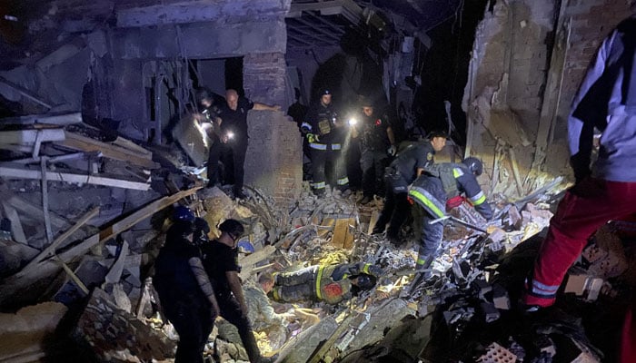 This handout photograph released on September 3, 2024 by Ukrainian State Emergency Service and taken on September 2, 2024 shows rescuers inspecting the rubble of a destroyed hotel after a Russian night strike in Zaporizhzhia, amid the Russian invasion of Ukraine.— AFP