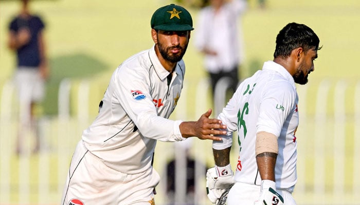 Pakistan´s captain Shan Masood (L) cheers to Bangladesh´s Litton Das after his dismissal for 138 runs during the third day of the second and last Test cricket match between Pakistan and Bangladesh, at the Rawalpindi Cricket Stadium in Rawalpindi on September 1, 2024.— AFP