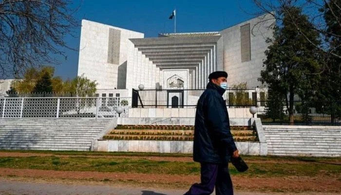 A policeman walks past the Supreme Court building in Islamabad, Pakistan. — AFP/File