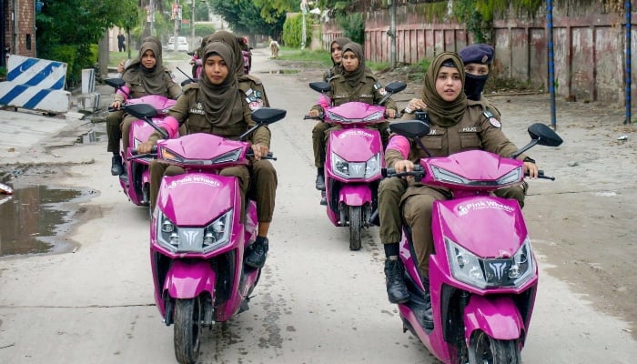 Women police personnel under Pakistans Pink Wheels project, initiated for women safety, patrol a street in Gujranwala on September 3, 2024. —AFP