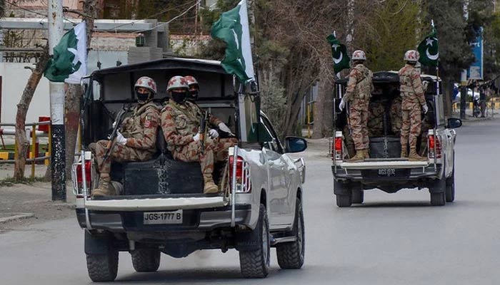 Security personnel patrol with vehicles on a street in Quetta, Pakistan, on March 25, 2020. — AFP