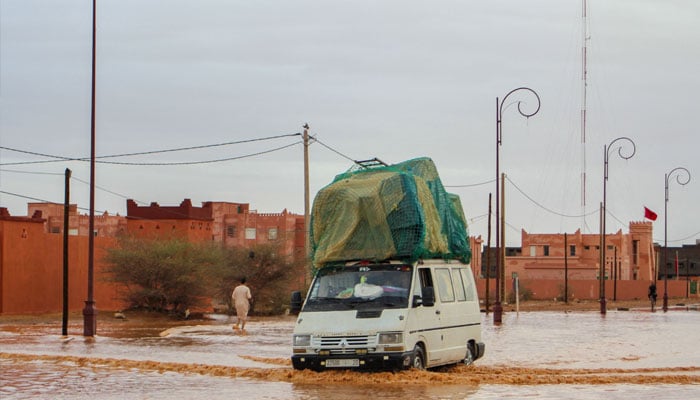 A car drives through a flooded street after flooding in Morocco´s region of Zagora on September 7, 2024. — AFP